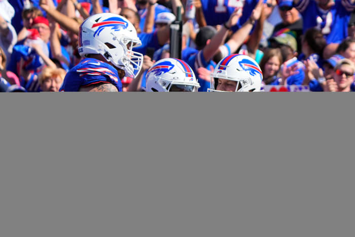 Josh Allen (17) celebrating with Stefon Diggs (14) and Spencer Brown (79) after a touchdown.